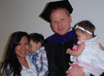 Photograph: Eslinger and family at Commencement